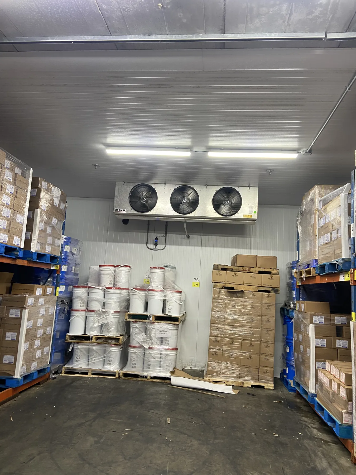 Walk-in cooler with evaporator unit at a commercial food storage facility